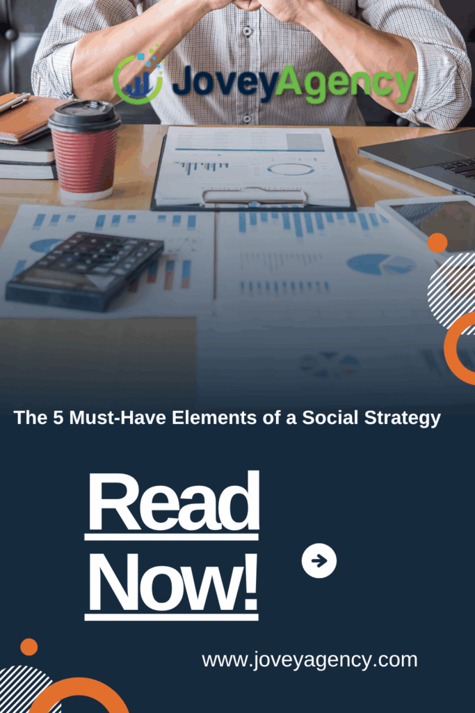 A Pinterest pin by Jovey Agency featuring a professional workspace with charts, graphs, a laptop, and a coffee cup. The text overlay reads "The 5 Must-Have Elements of a Social Strategy" followed by a bold call to action: "Read Now!" with an arrow. The design includes modern graphic accents and displays the website www.joveyagency.com.